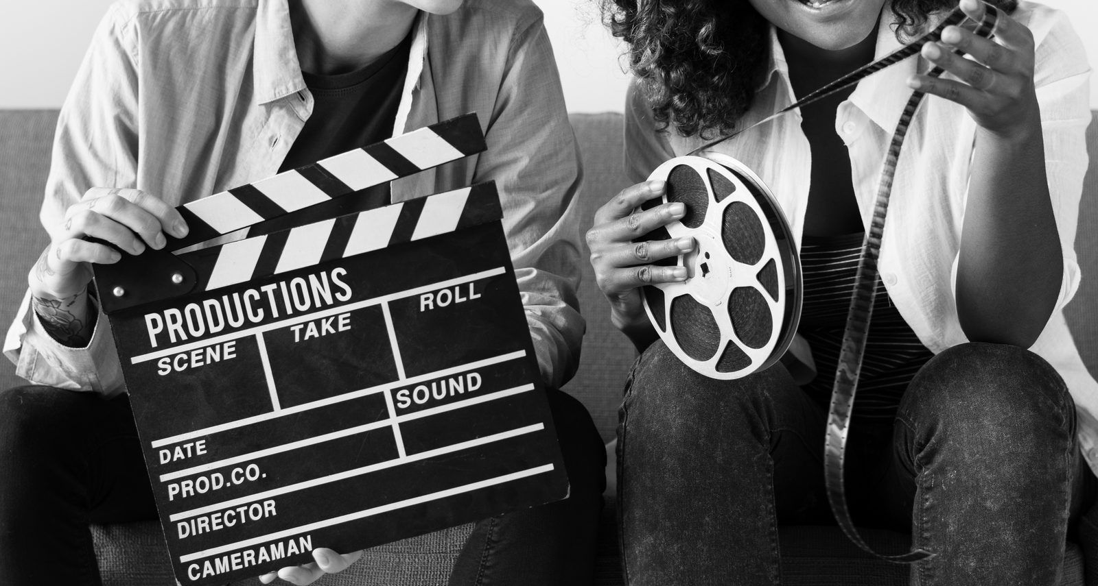 A film clapperboard held open on set